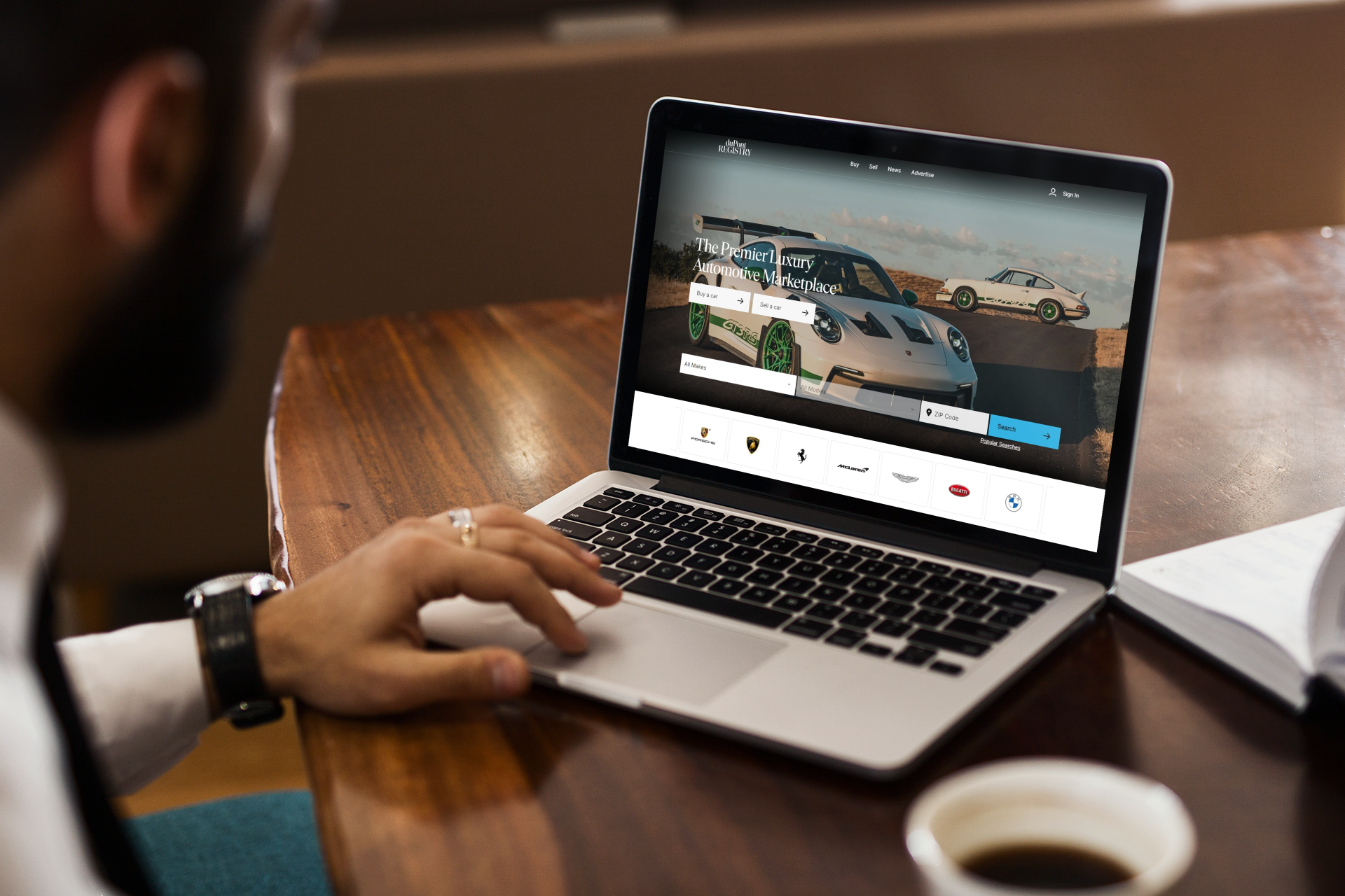 mockup-featuring-a-man-using-his-macbook-pro-on-a-wooden-desk-2321-el1